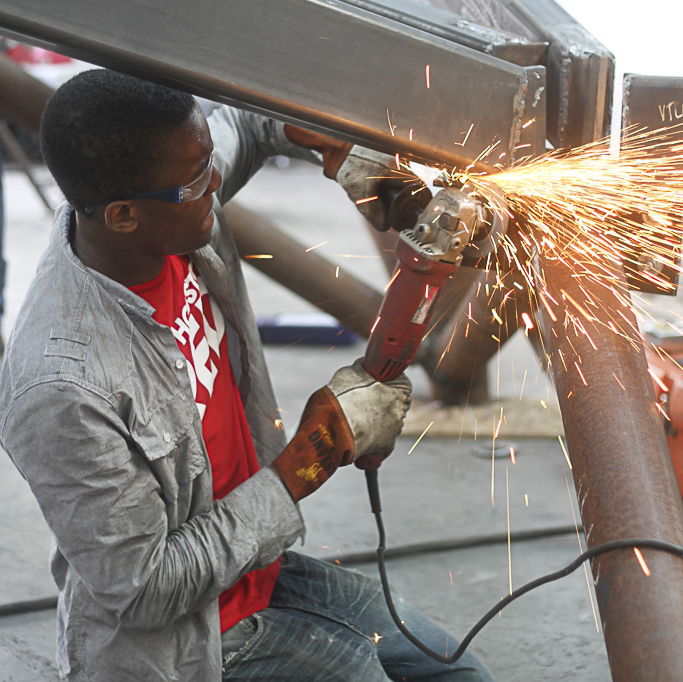 Student using metalworking tools.