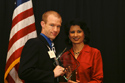 Dr. Brian McFarlin receives the award from UH President Dr. Khator