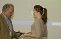  TACSM president Dr. Stephen Morris presenting an award to HHP grad student Kelley Strohacker