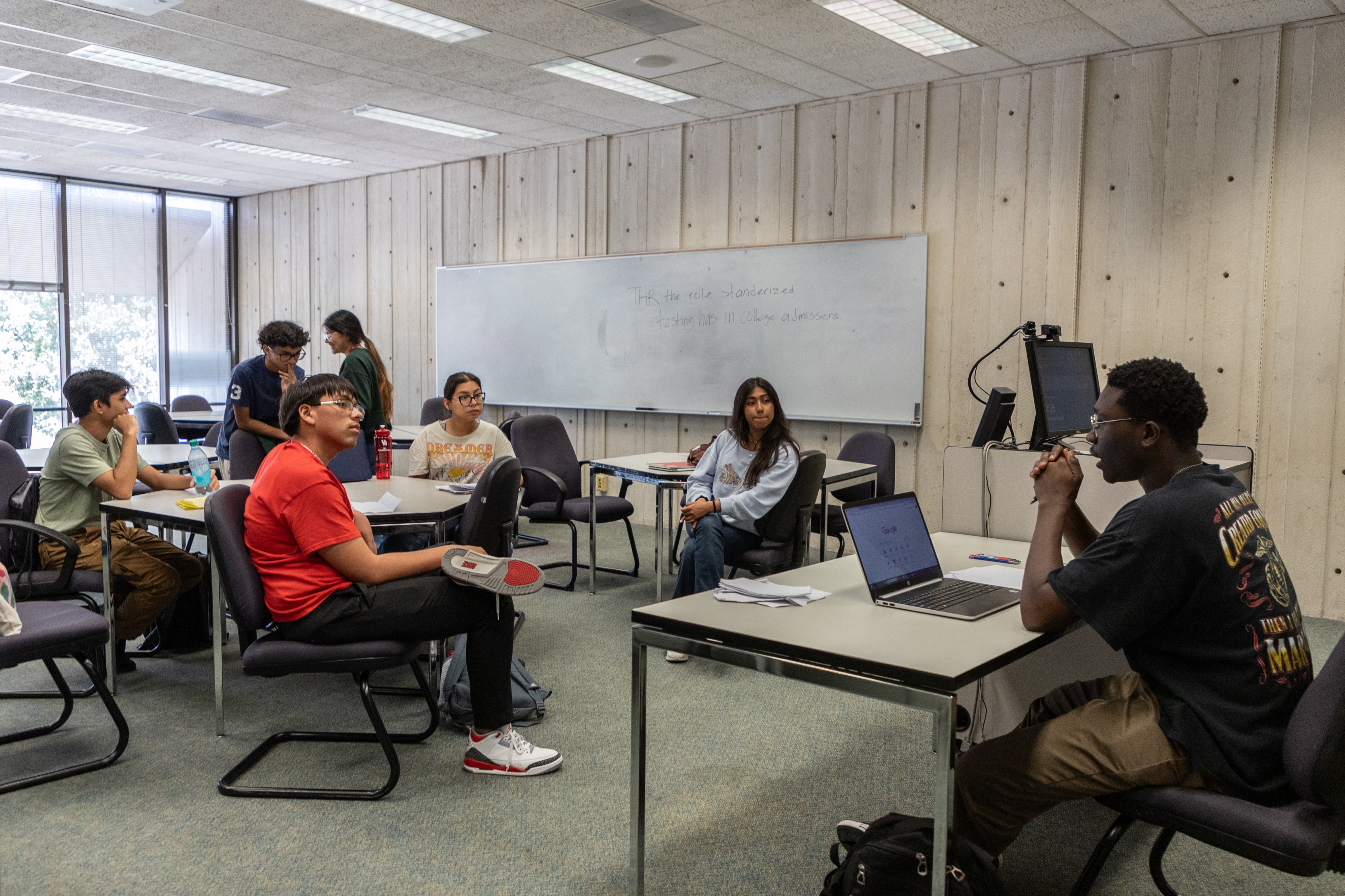 debate instructor with students in class