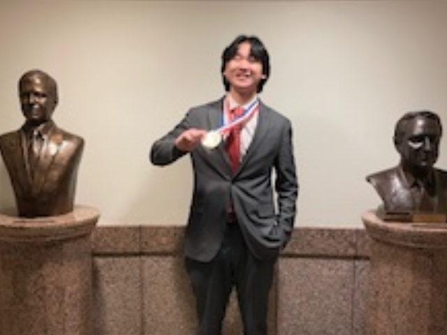 student with winning medal