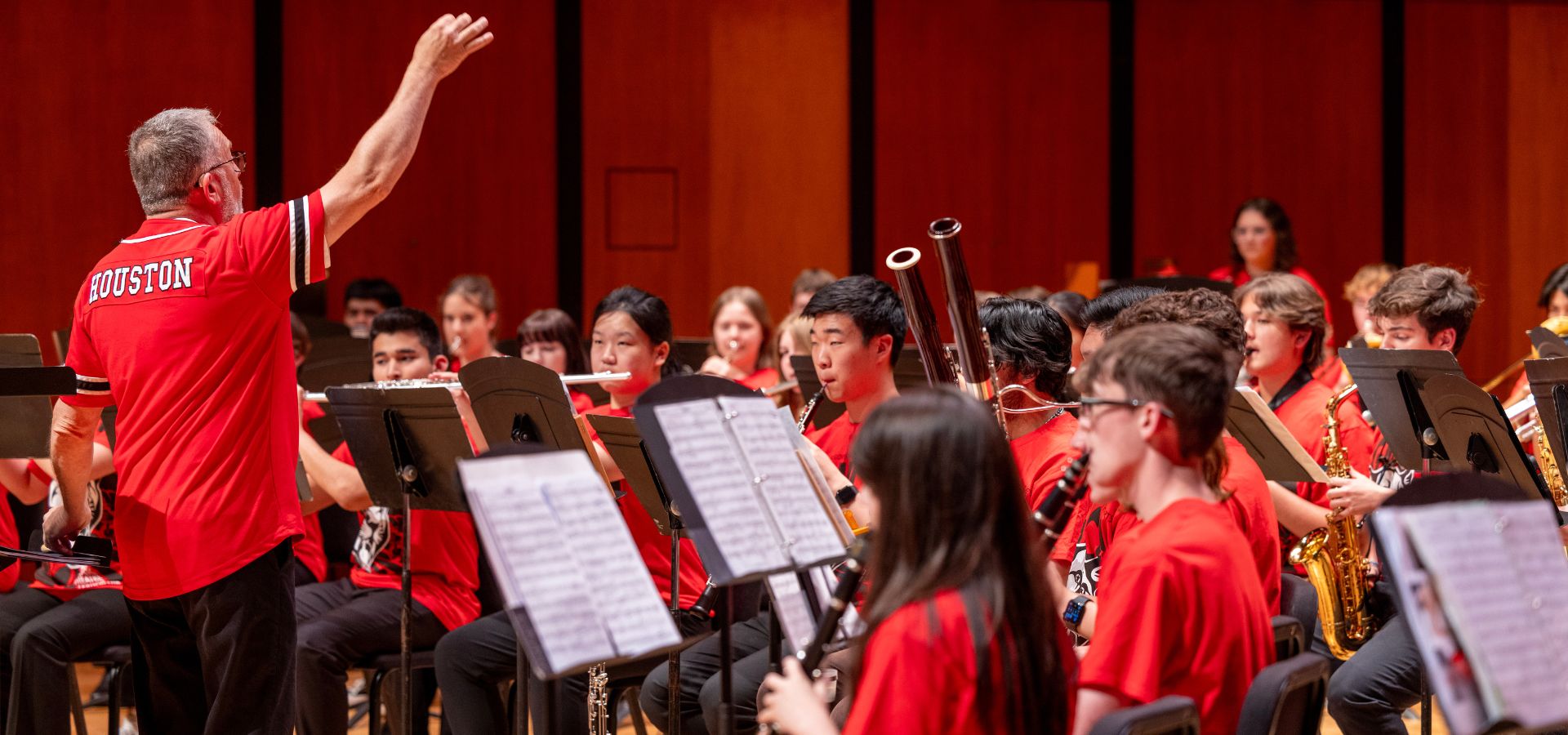 David Bertman in a UH shirt conducting the High School Honor Band Project