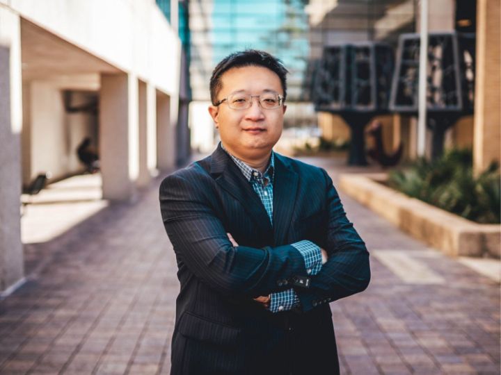 Associate Professor Jian Shi crosses his arms for a photo.