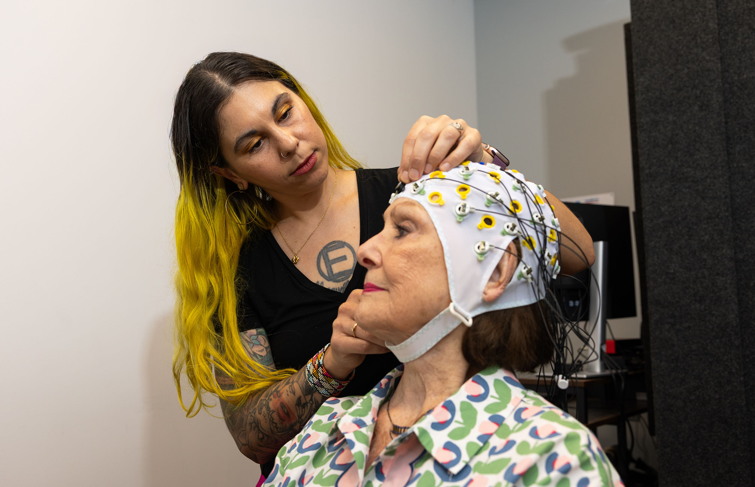 neuroscientist heather dial fits a patient with an eeg cap