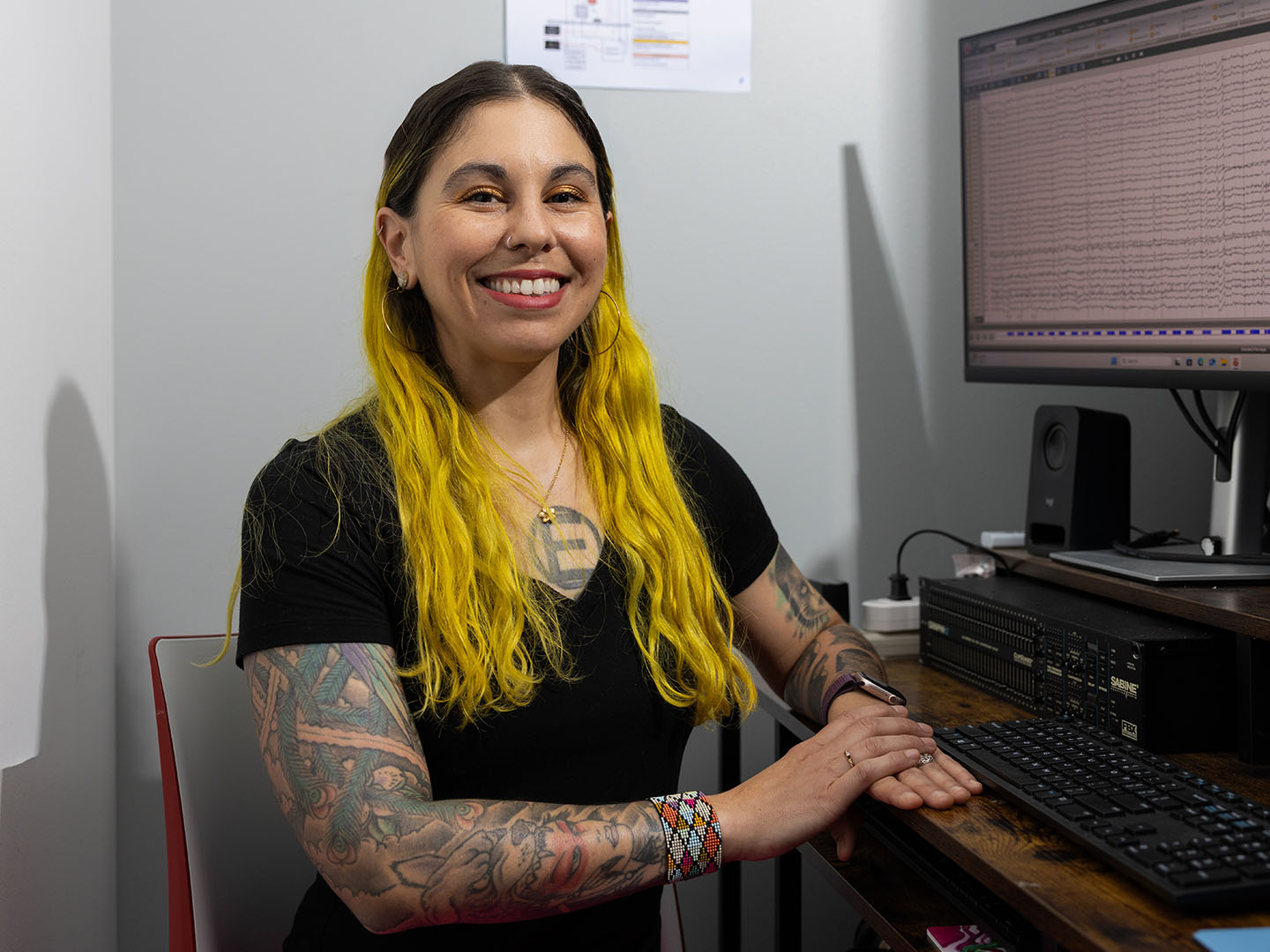 university of houston researcher heather dial smiles next to a computer