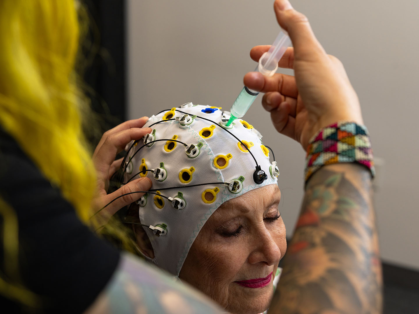 neuroscientist heather dial fits a patient with an eeg cap